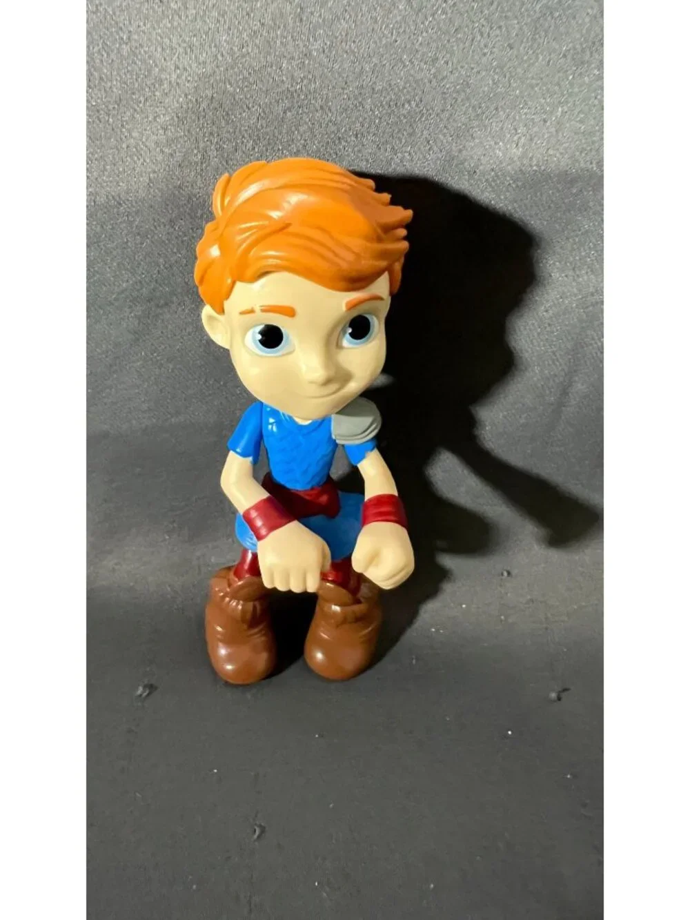 Red-Haired Action Figure In Blue Outfit With Brown Boots